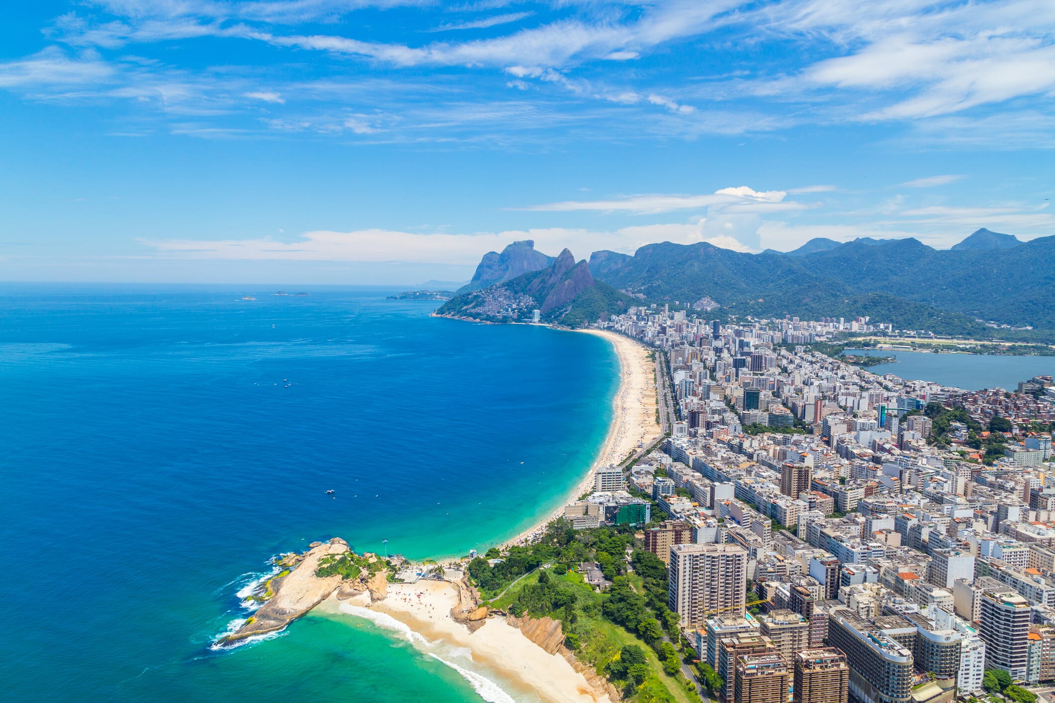 Aerial view of the Ipanema Beach in Rio de Janeiro on a summer day, full of people enjoying themselves on it's clear blue water. One of the most famous beaches in the world next to the Copacabana Beach, Ipanema is widely visited by tourists from all around the world.